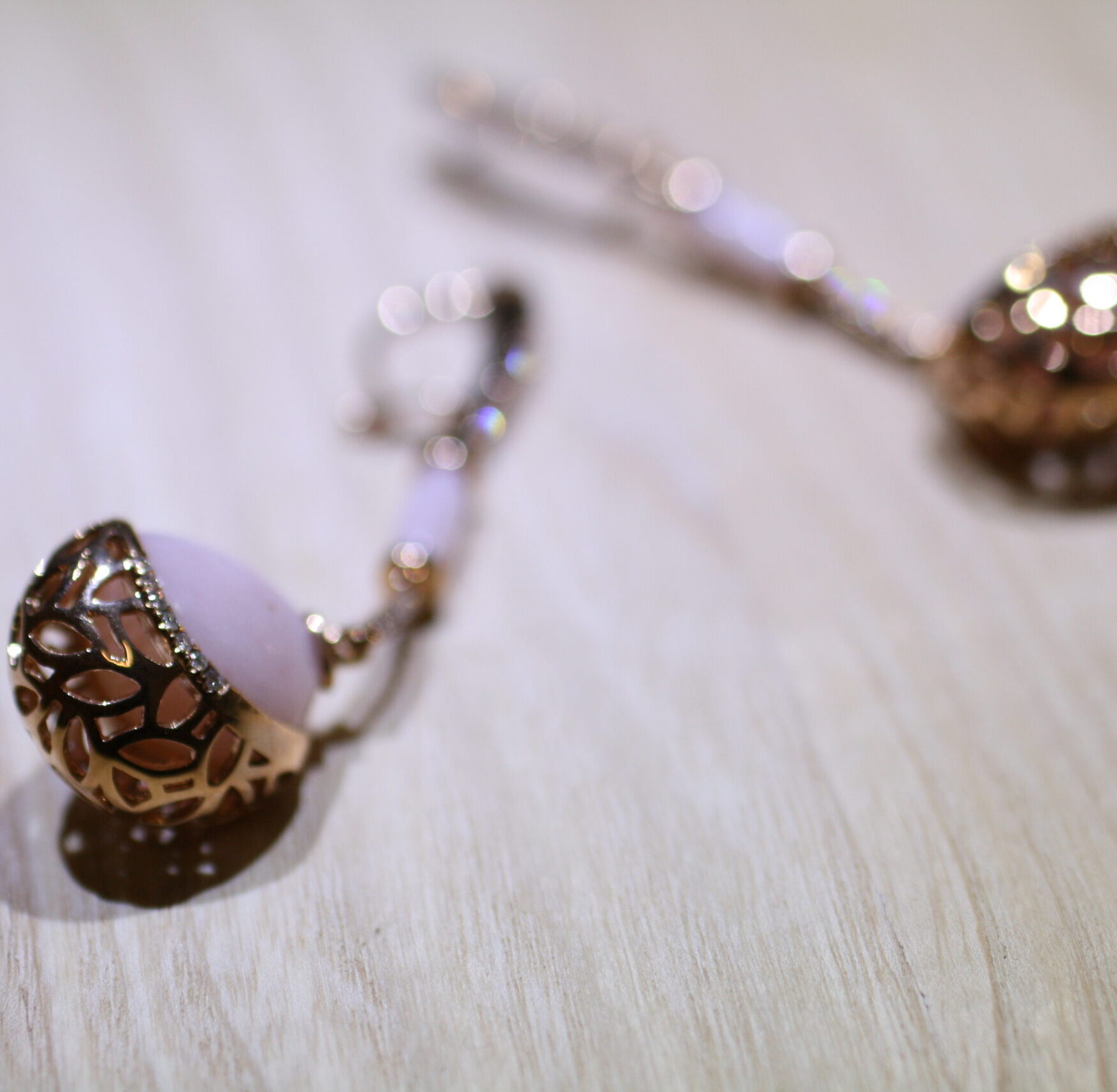 leaf motif rose gold with pink opal and diamond earrings from Bayside Collection by MIYOCO on the wooden table