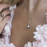 Moonlight serenade collection, a Tahitian pearls and diamond ring in white gold wearing in a pink sakura dress at the cocktail party