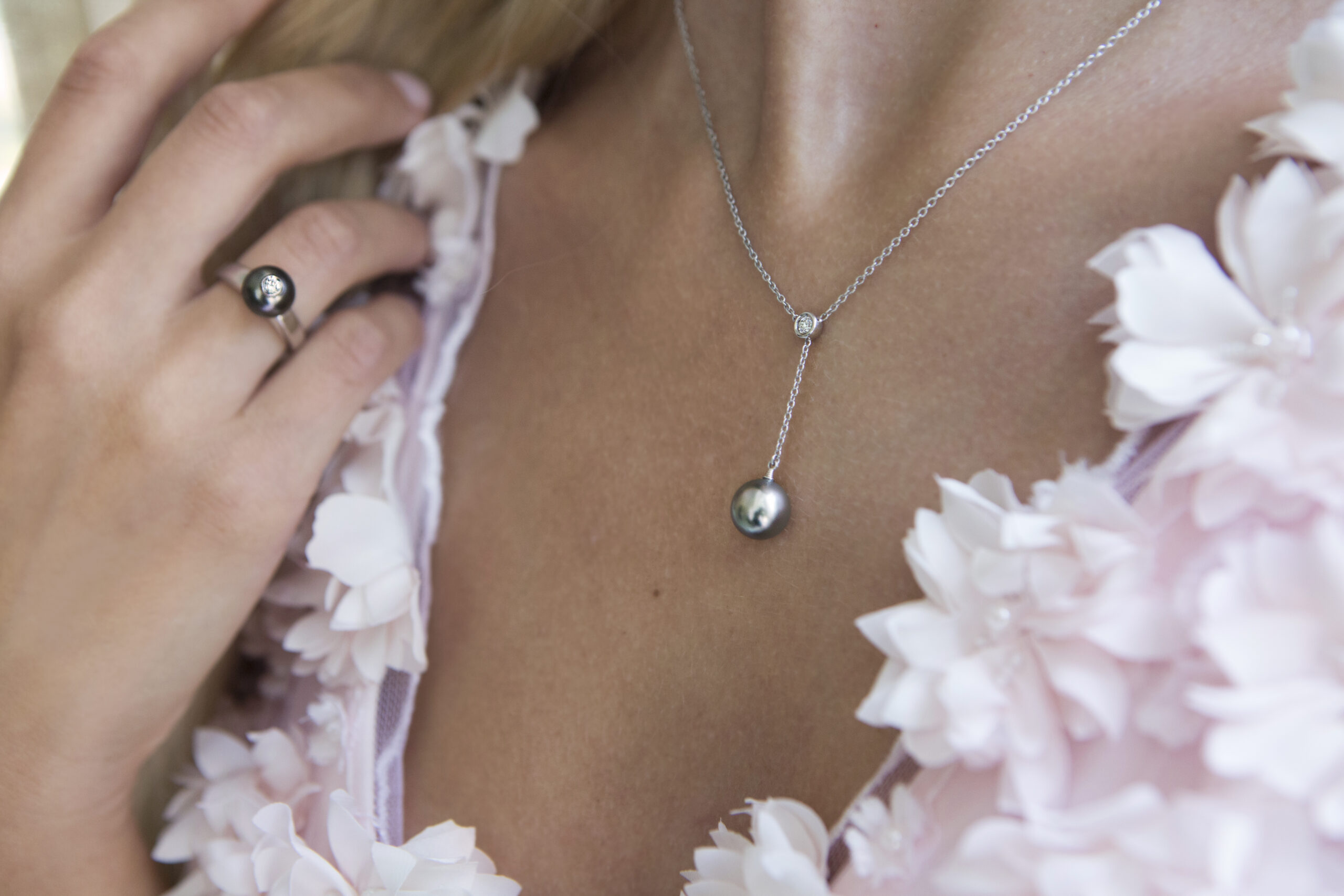 Moonlight serenade collection, a Tahitian pearls and diamond ring in white gold wearing in a pink sakura dress at the cocktail party