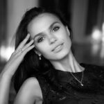 Model in black dress wearing horse shoe motif diamond jewellery set crafted in rose gold and white gold